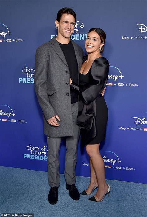 gina rodriguez looks classic in a black cocktail dress as she packs on pda with husband joe