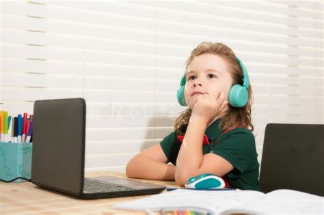 Home Schooling Concept School Boy In Headset Watching Online Lesson On