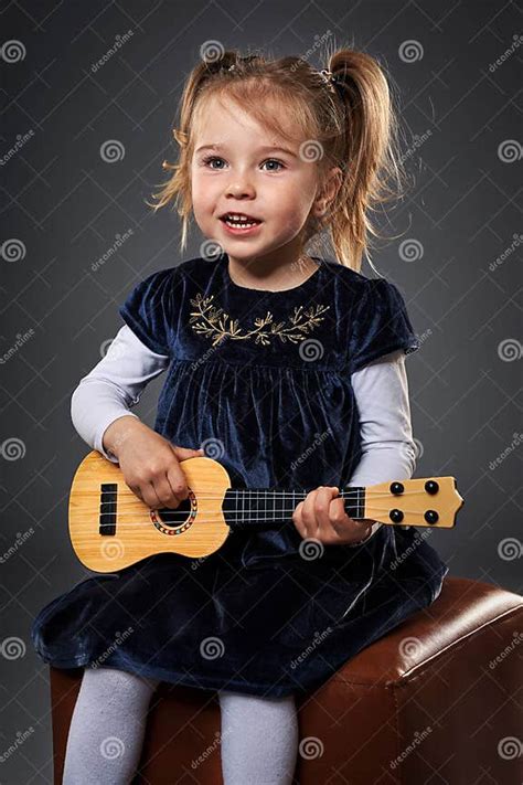 Little Girl Playing Guitar Stock Photo Image Of Guitar 216587976