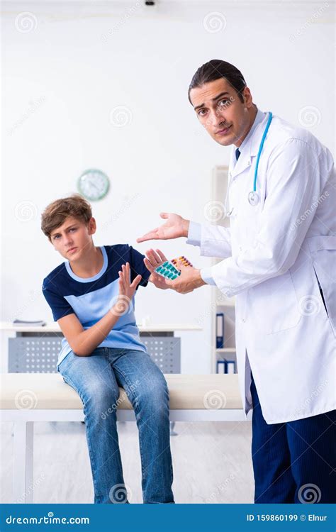 Young Male Doctor Examining Boy In The Clinic Stock Image Image Of