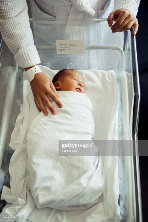 Newborn Baby Boy Asleep In Hospital Bassinet High Res Stock Photo