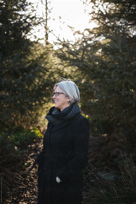 Happy Middle Aged Caucasian Woman Smiling Outside In Nature By Stocksy Contributor Rob And