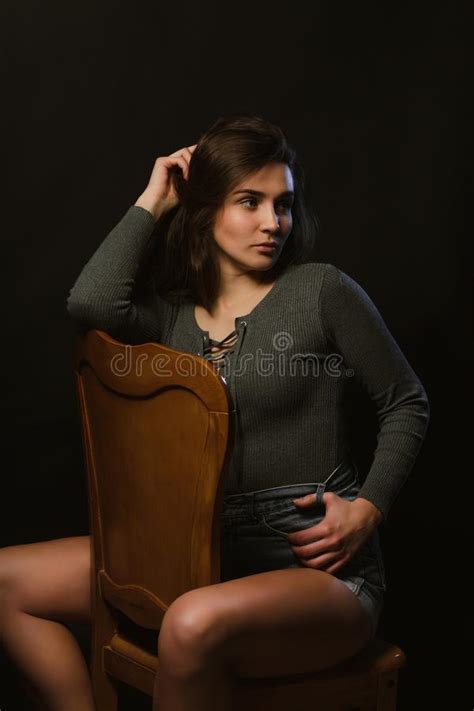 Expressive Brunette Girl Posing In Studio During Model Tests Dressed In