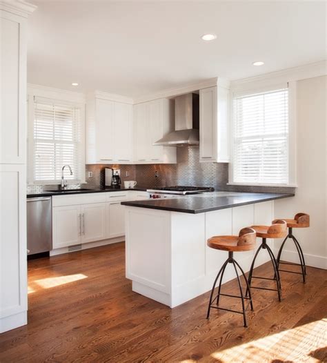 Pictures of our beautifully remodeled kitchens in this gallery. White Kitchen Peninsula with Black Countertop