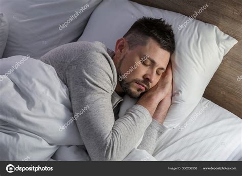 Handsome Man Sleeping In Bed At Night Stock Photo By ©serezniy 330236358