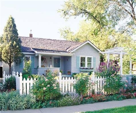 Blue Cottage With White Picket Fence Front Yard Garden Fenced In Yard
