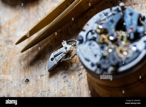 Opened Watch Mechanism On A Watchmakers Bench With Selective Focus To A