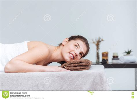 Happy Pretty Young Woman Smiling And Lying In Spa Salon Stock Image