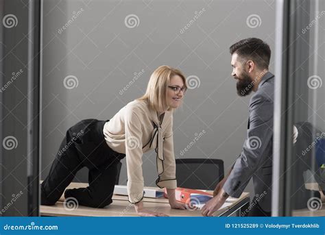 office romance concept secretary seduce boss in office businesswoman on desktop look at