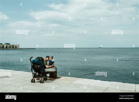 Father And Baby Boy On A Waterfront Promenade On The Adriatic Sea