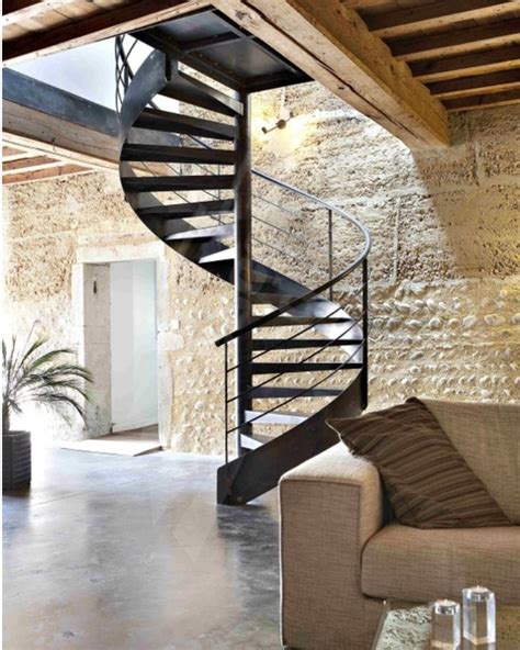 Black Metal Spiral Staircase Contrasts With Light Textured Walls Loft