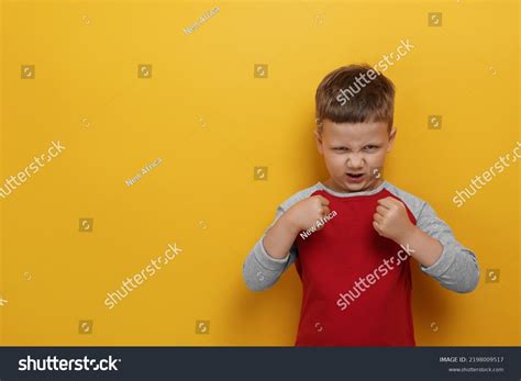 Angry Little Boy On Yellow Background Stock Photo 2198009517 Shutterstock