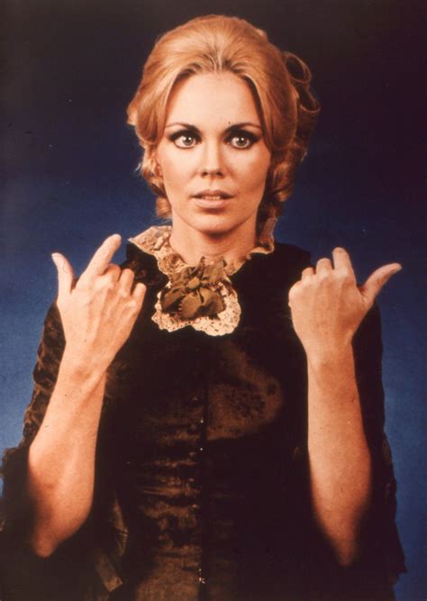 The Woman Is Posing With Her Hands Up In Front Of Her Face And Wearing A Black Dress