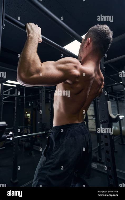 Strong Sportsman Demonstrating His Muscles During Training Stock Photo