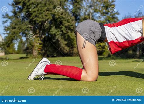lovely blonde female golfter enjoying a round of golf on a public golf course stock image