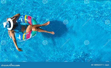 Beautiful Girl In Hat In Swimming Pool Aerial Top View From Above