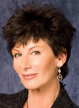 A Woman With Short Black Hair And Earrings