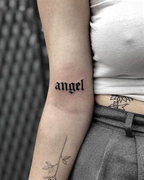 A Word ‘angel Tattooed In A Medieval Style Font On The Right Arm By Loz Mclean Intimate