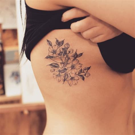 Find the perfect rib cage stock photo. Blackwork cherry blossoms on rib cage | Cage tattoos ...