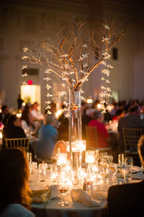 Tall Manzanita Branch Centerpiece With Hanging Orchids And Candles