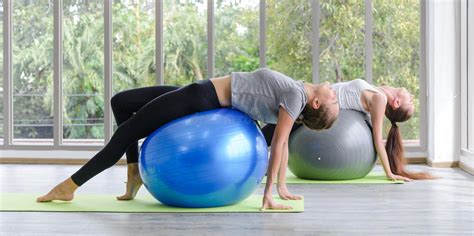 Two Caucasian Women Exercising With Exercise Ball Fitness Girls