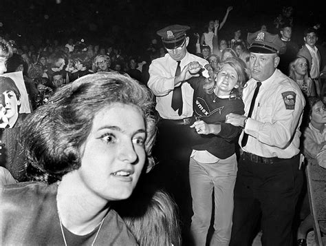 Hysterical Fans Are Apprehended By Police During A Beatles Concert In