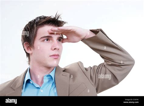 Young Businessman Holding His Hand To His Forehead Protecting His Eyes