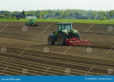 Tractors Plow The Field And Prepare The Soil For Sowing Stock Photo