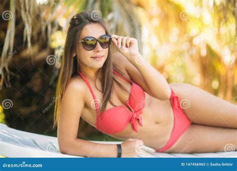 Young Woman Relaxing On Deck Chair Beautiful Woman In Pink Bikini Lying Near Sea Stock Image