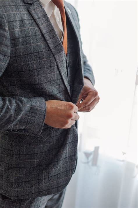 A Man And A Successful Businessman Straightens His Jacket Stock Photo