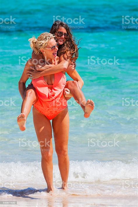 Lesbian Couple On Vacation At The Beach In The Bahamas Stock Photo
