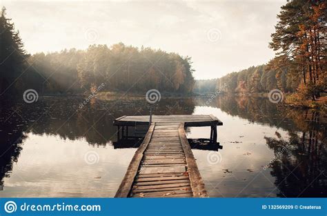 The Breath Of Autumn Fog Lake In Morning With Boat Dock Stock Image