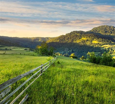 Fence On Hillside Meadow In Mountain At Sunrise Stock Image Image Of