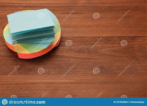 Stack Of Colorful Stickers On Wooden Table Space For Text Stock Photo