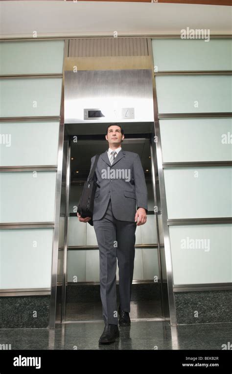 Businessman Stepping Out Of An Elevator Stock Photo Alamy