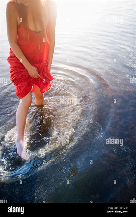 Woman In Red Dress Standing In Lake Stock Photo Alamy