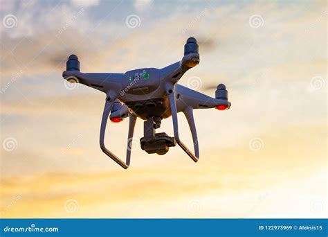 Professional Drone Quad Copter With Digital Camera At Sunset Ready To