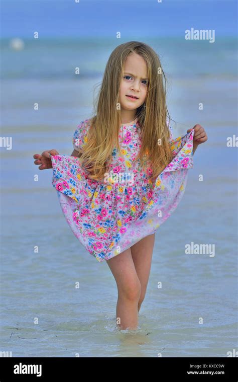 Cute Little Girl On Sandy Beach Blue Ocean And Sky Background Cuba