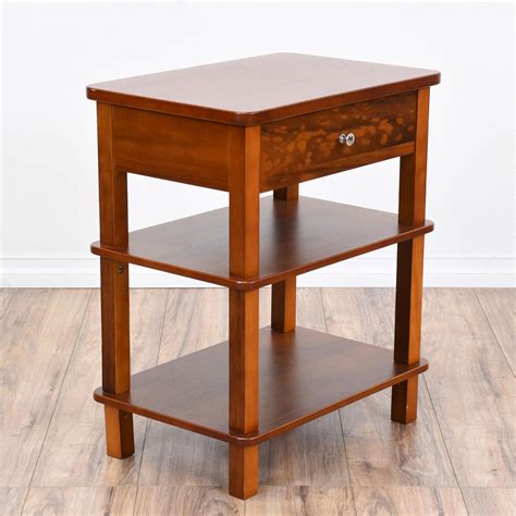 This 3 Tiered End Table Is Featured In A Solid Wood With A Glossy Light