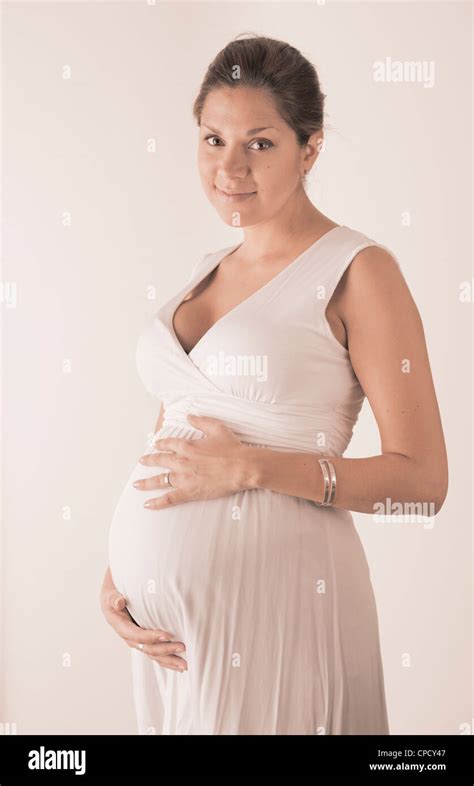 Pregnant Woman Holding Hands On Her Stomach Stock Photo Alamy