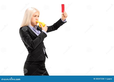 Young Businesswoman Blowing A Whistle And Showing A Red Card Stock