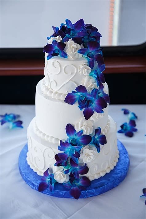 round white wedding cake with swirls and blue orchid flowers mmtb wedding cakes pinterest
