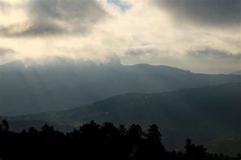 The Sun Shines Through The Clouds Above The Mountains 14947930 Stock