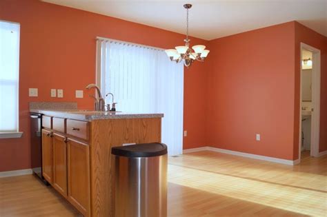 Dark hardwood floors also work to anchor the room. This burnt orange paint is beautiful and bold, perfect for ...