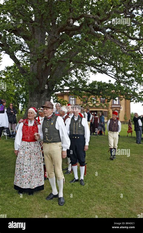 People In Traditional Swedish Folk Costumes At Midsummer Celebration