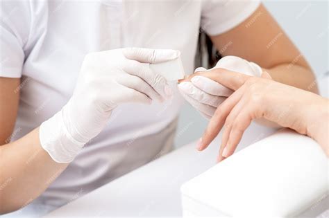 Premium Photo Close Up On Hand Receiving Nail Care Procedure