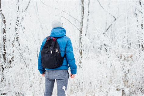 Young Man Standing All Alone In The Winter Snowy Forest Stock Image