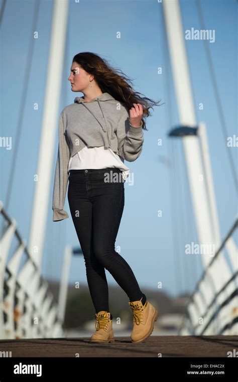 A Young 13 14 15 Year Old Teenage Girl Outdoors Standing On A Bridge