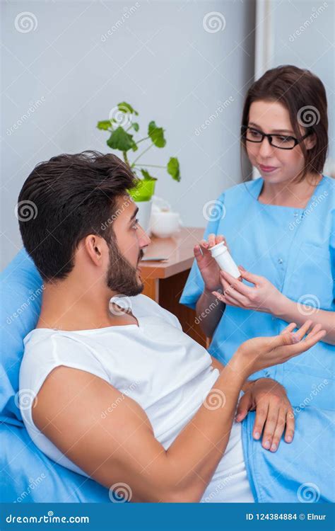 The Woman Doctor Examining Male Patient In Hospital Stock Photo Image