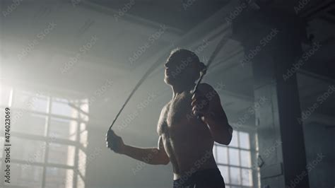 Athlete Jumping On Skipping Rope Muscular Man With Naked Torso Using Jump Rope Stock Adobe